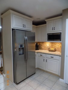 white kitchen cabinets around fridge